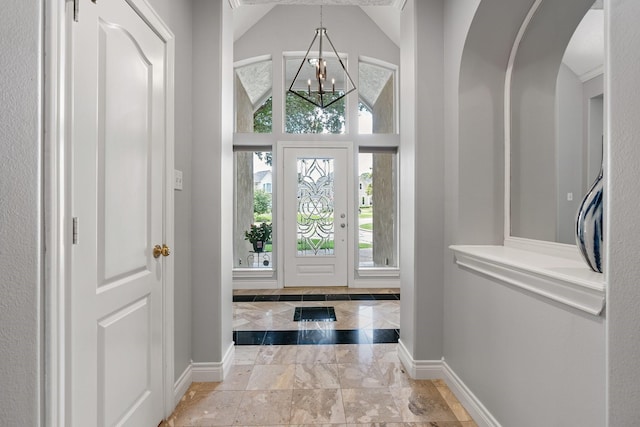60 Fairfield Dr, Montgomery, TX 77356 - entryway featuring baseboards, a chandelier, arched walkways, and marble finish floors