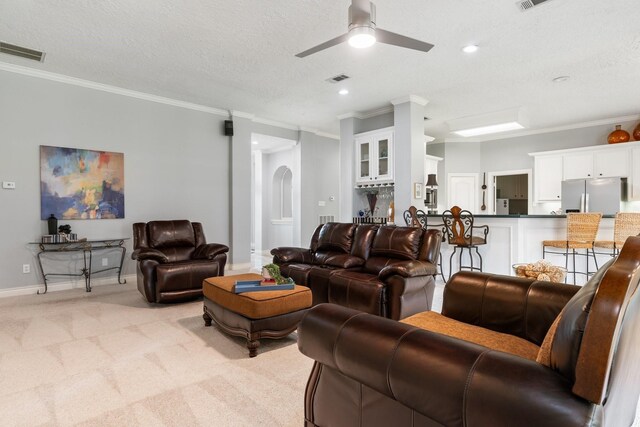 60 Fairfield Dr, Montgomery, TX 77356 - living area featuring ornamental molding, light carpet, a ceiling fan, baseboards, and a textured ceiling