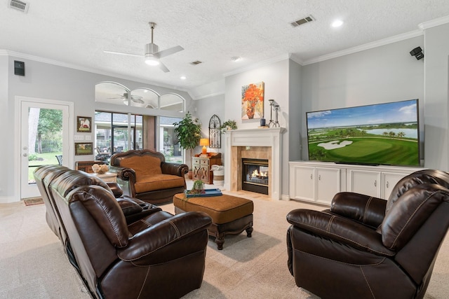 60 Fairfield Dr, Montgomery, TX 77356 - living area with light colored carpet, ceiling fan, a textured ceiling, crown molding, and a tile fireplace