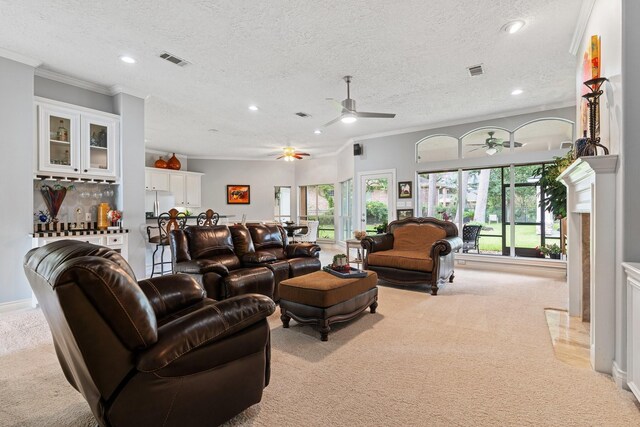 60 Fairfield Dr, Montgomery, TX 77356 - carpeted living room featuring ceiling fan, ornamental molding, plenty of natural light, recessed lighting, and a textured ceiling