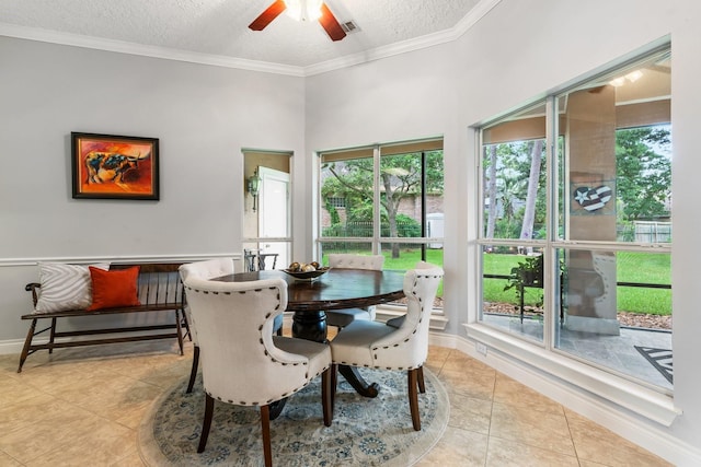 60 Fairfield Dr, Montgomery, TX 77356 - dining room with light tile patterned floors, plenty of natural light, ceiling fan, crown molding, and a textured ceiling