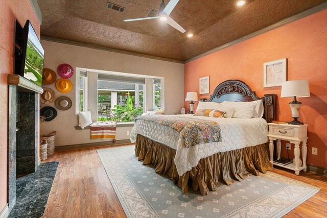 60 Fairfield Dr, Montgomery, TX 77356 - bedroom featuring a fireplace, wood finished floors, baseboards, lofted ceiling, and crown molding