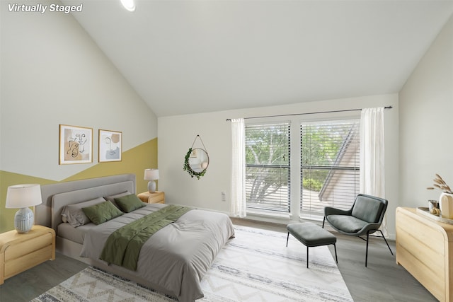4144 Greystone Way Unit 305, Sugar Land, TX 77479 - bedroom featuring wood finished floors, lofted ceiling, access to exterior, and baseboards