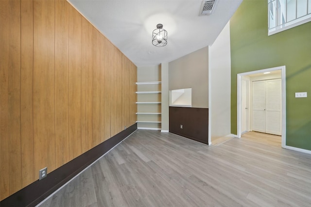 4144 Greystone Way Unit 305, Sugar Land, TX 77479 - spare room with wood finished floors, baseboards, a chandelier, and built in shelves