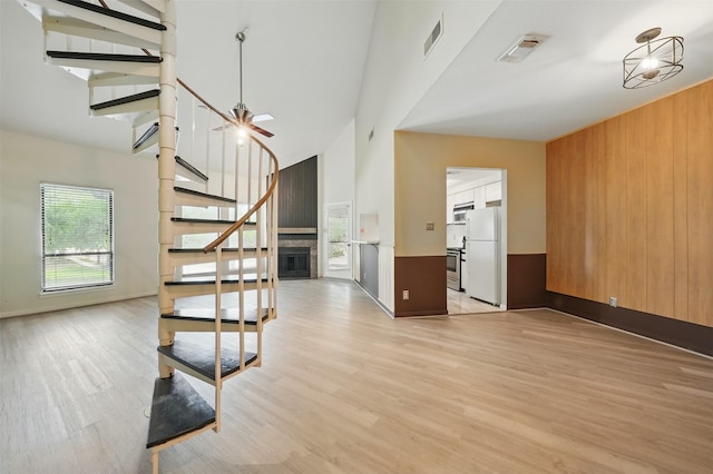4144 Greystone Way Unit 305, Sugar Land, TX 77479 - stairway featuring high vaulted ceiling, wood finished floors, baseboards, and wood walls
