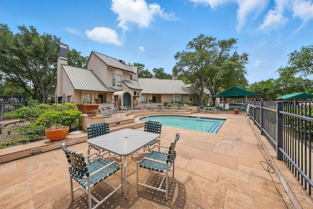 4144 Greystone Way Unit 305, Sugar Land, TX 77479 - community pool featuring a patio, fence, and outdoor dining space