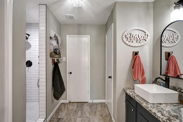 25401 Hunting Trl, Magnolia, TX 77355 - full bathroom with baseboards, a tile shower, vanity, and marble look tile flooring
