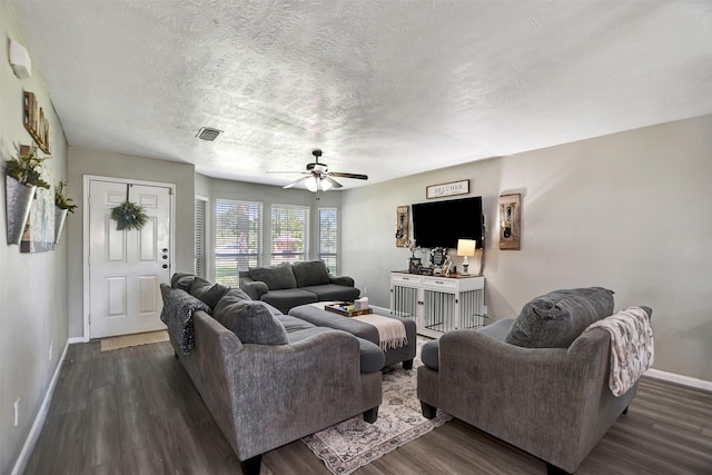 25401 Hunting Trl, Magnolia, TX 77355 - living area featuring baseboards, dark wood finished floors, ceiling fan, and a textured ceiling
