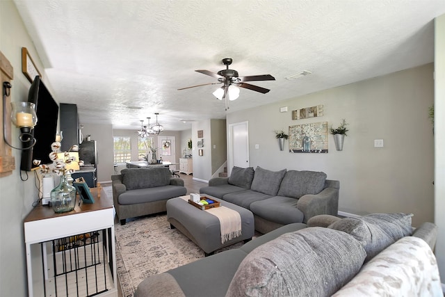 25401 Hunting Trl, Magnolia, TX 77355 - living area featuring ceiling fan, a chandelier, a textured ceiling, stairway, and baseboards