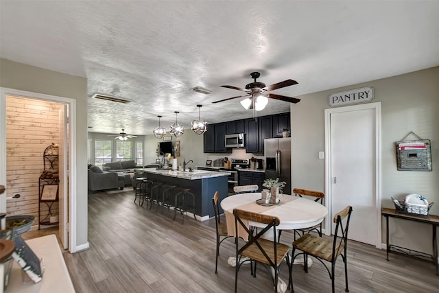 25401 Hunting Trl, Magnolia, TX 77355 - dining space with ceiling fan and wood finished floors