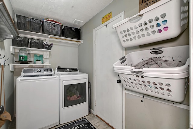 25401 Hunting Trl, Magnolia, TX 77355 - clothes washing area featuring washer and clothes dryer and a textured ceiling
