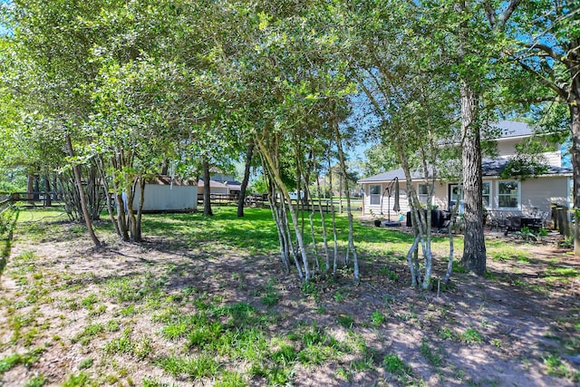 25401 Hunting Trl, Magnolia, TX 77355 - view of yard featuring fence, an outbuilding, and a storage shed