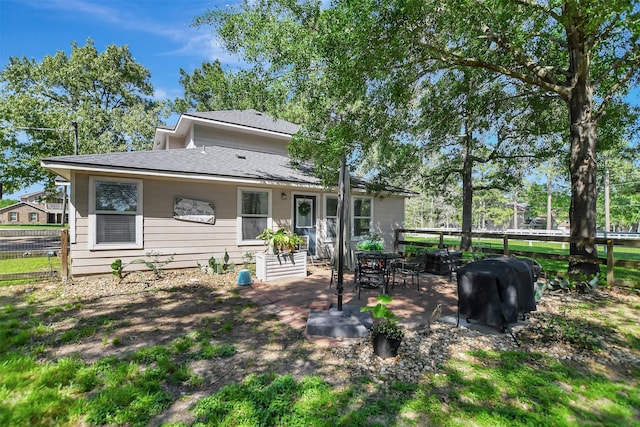 25401 Hunting Trl, Magnolia, TX 77355 - rear view of house featuring a shingled roof, fence, and a patio area