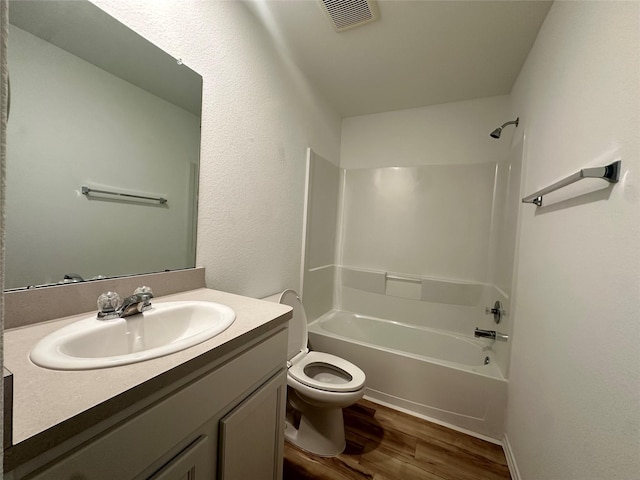 11079 N Lake Mist Ln, Willis, TX 77318 - full bath with wood finished floors, bathing tub / shower combination, toilet, and vanity