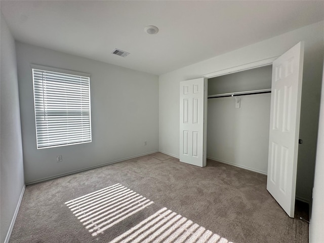 11079 N Lake Mist Ln, Willis, TX 77318 - unfurnished bedroom featuring carpet flooring, a closet, and baseboards