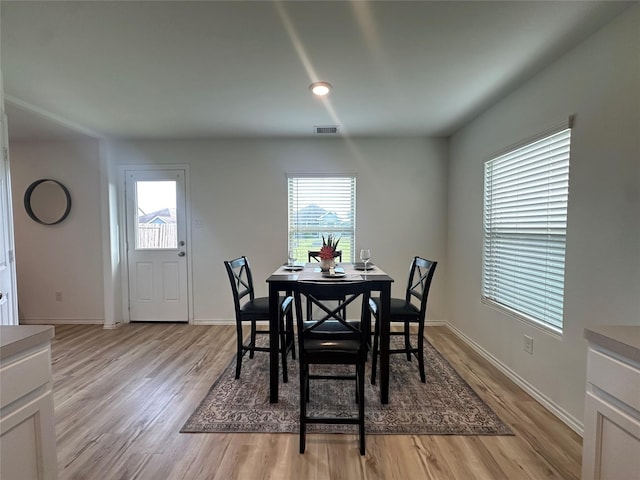 11079 N Lake Mist Ln, Willis, TX 77318 - dining space featuring light wood-style flooring and baseboards