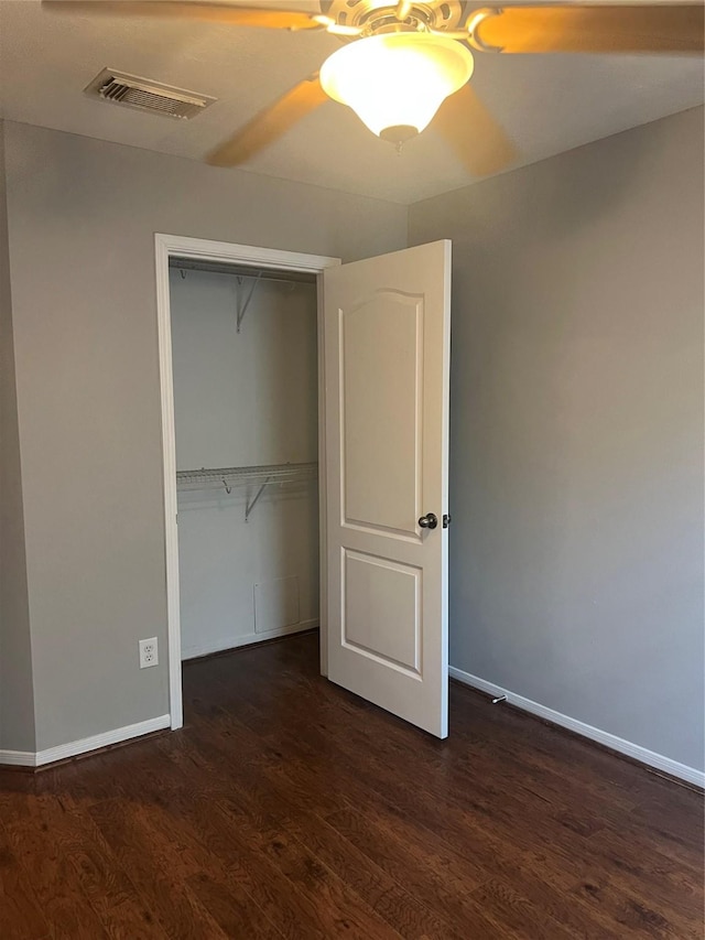 5339 Canyon Hollow Dr, Houston, TX 77084 - unfurnished bedroom featuring dark wood-style flooring, baseboards, a closet, and ceiling fan