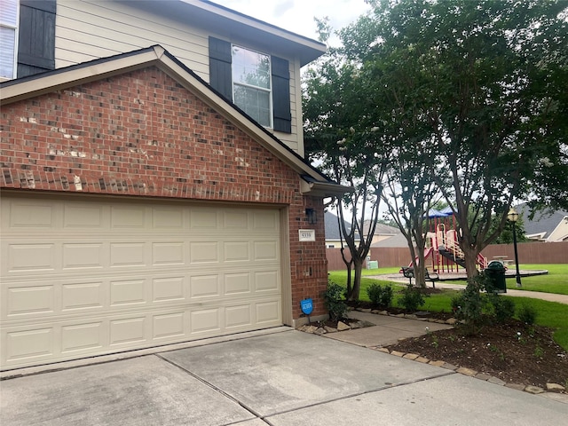 5339 Canyon Hollow Dr, Houston, TX 77084 - view of side of home featuring brick siding, a garage, and driveway