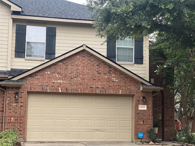5339 Canyon Hollow Dr, Houston, TX 77084 - view of front of home featuring brick siding, concrete driveway, and roof with shingles