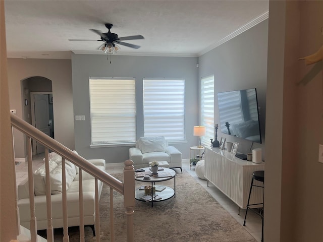 5339 Canyon Hollow Dr, Houston, TX 77084 - living area with arched walkways, a ceiling fan, light tile patterned flooring, crown molding, and baseboards