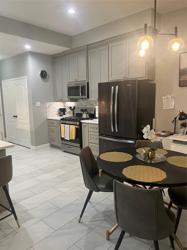 5339 Canyon Hollow Dr, Houston, TX 77084 - kitchen with stainless steel appliances, backsplash, gray cabinetry, light countertops, and recessed lighting