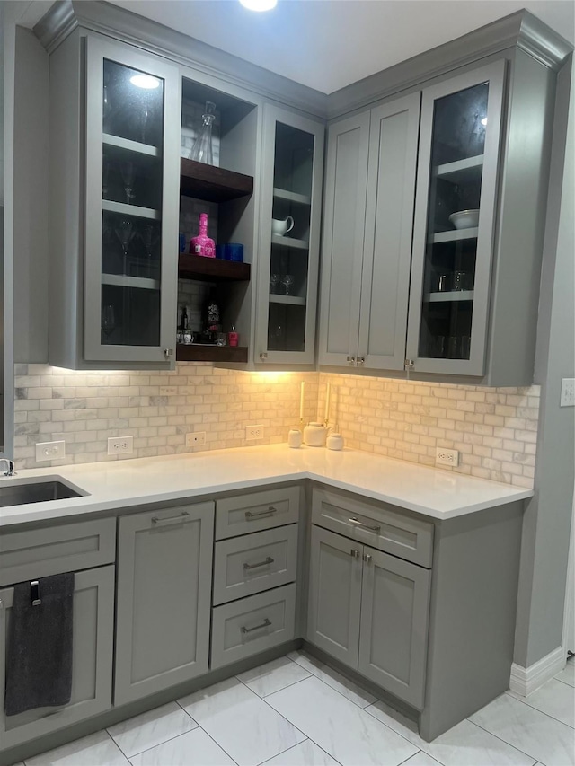 5339 Canyon Hollow Dr, Houston, TX 77084 - bar featuring decorative backsplash, light marble finish floors, and a sink