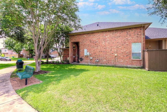 5339 Canyon Hollow Dr, Houston, TX 77084 - rear view of house with brick siding, a lawn, and a shingled roof