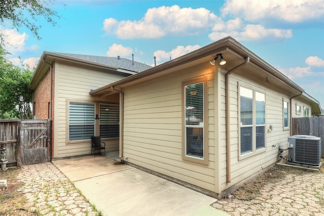 5339 Canyon Hollow Dr, Houston, TX 77084 - view of side of home with central air condition unit, a patio, and a gate
