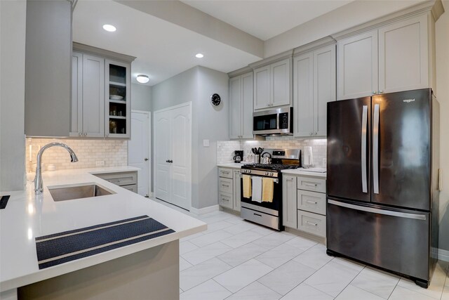 5339 Canyon Hollow Dr, Houston, TX 77084 - kitchen with stainless steel appliances, a sink, light countertops, tasteful backsplash, and recessed lighting