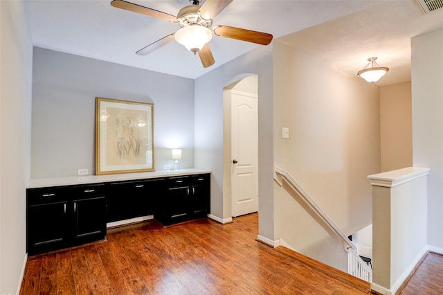 5339 Canyon Hollow Dr, Houston, TX 77084 - hall featuring an upstairs landing, arched walkways, dark wood finished floors, and baseboards