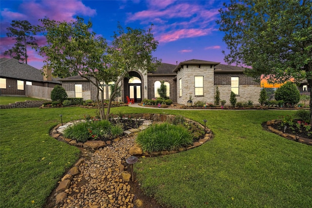 40610 Ithaca Ln, Magnolia, TX 77354 - french country home with french doors, a lawn, stone siding, and a shingled roof