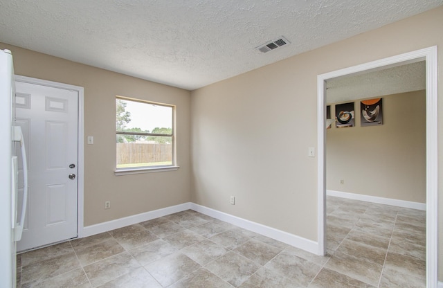 18011 Glenledi Dr, Houston, TX 77084 - empty room featuring a textured ceiling and baseboards