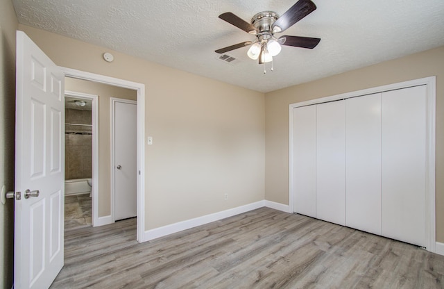 18011 Glenledi Dr, Houston, TX 77084 - unfurnished bedroom with light wood-style flooring, a textured ceiling, a closet, baseboards, and ceiling fan