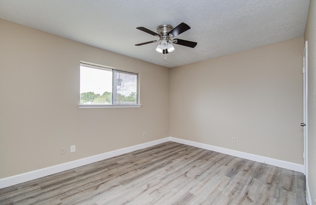 18011 Glenledi Dr, Houston, TX 77084 - spare room featuring wood finished floors, a ceiling fan, baseboards, and a textured ceiling