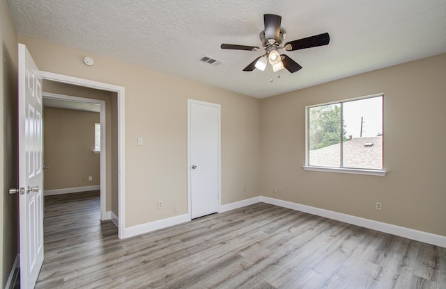 18011 Glenledi Dr, Houston, TX 77084 - unfurnished room with light wood-style floors, a ceiling fan, and baseboards