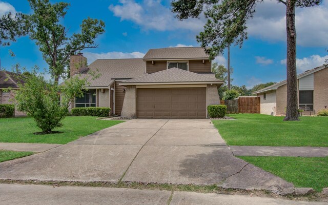 18011 Glenledi Dr, Houston, TX 77084 - view of front facade with a garage, concrete driveway, brick siding, and a shingled roof