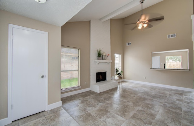 18011 Glenledi Dr, Houston, TX 77084 - unfurnished living room featuring baseboards, a ceiling fan, high vaulted ceiling, and a fireplace