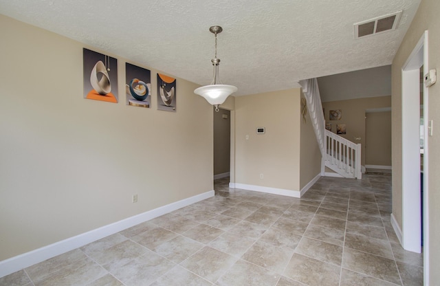 18011 Glenledi Dr, Houston, TX 77084 - empty room with a textured ceiling, light tile patterned floors, and baseboards