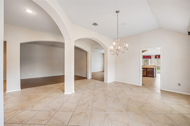 31827 Oak Thicket Ct, Conroe, TX 77385 - empty room with vaulted ceiling, light tile patterned flooring, and a chandelier