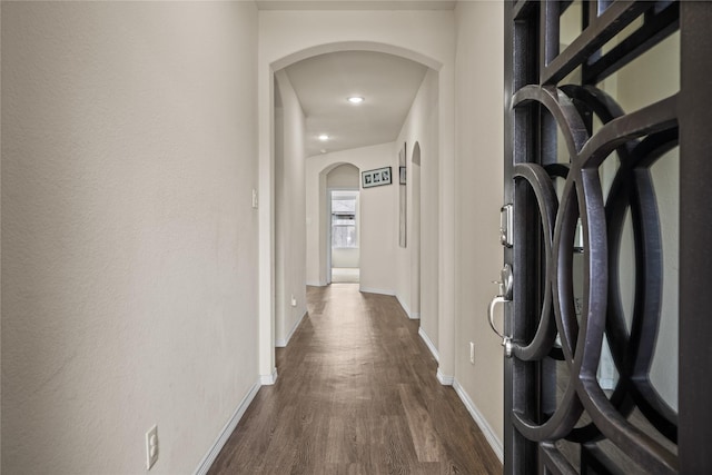 13030 Larriston Ln, Houston, TX 77044 - hall featuring arched walkways, dark wood-style flooring, and baseboards