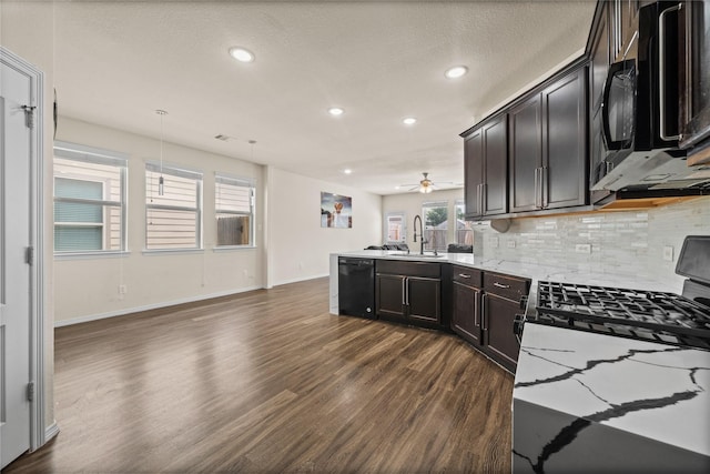 13030 Larriston Ln, Houston, TX 77044 - kitchen featuring dishwasher, a peninsula, dark wood-style floors, backsplash, and gas stove