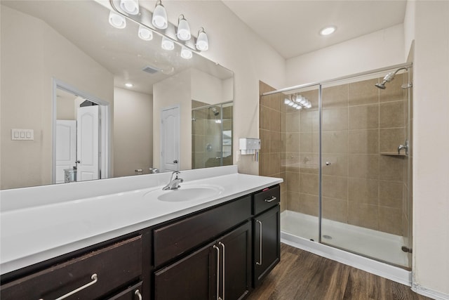 13030 Larriston Ln, Houston, TX 77044 - full bathroom featuring a stall shower, wood finished floors, and vanity