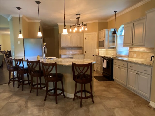 216 Dewberry Dr, Lake Jackson, TX 77566 - kitchen featuring freestanding refrigerator, tasteful backsplash, ornamental molding, white cabinets, and black / electric stove