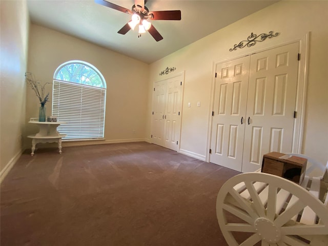 216 Dewberry Dr, Lake Jackson, TX 77566 - unfurnished bedroom with dark colored carpet, baseboards, multiple closets, a ceiling fan, and vaulted ceiling