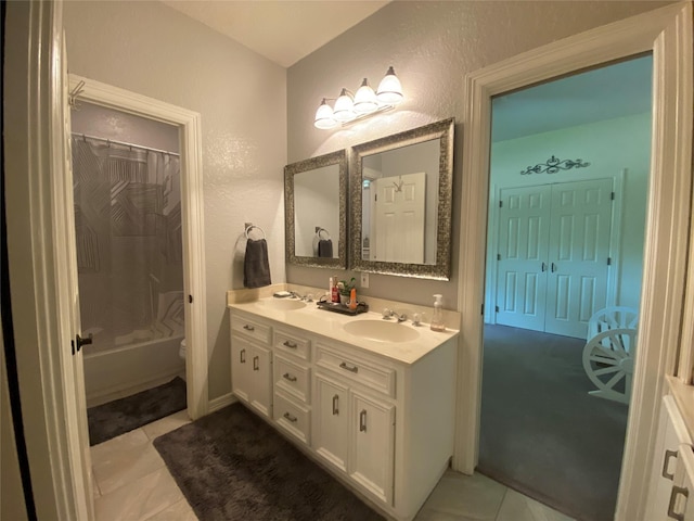 216 Dewberry Dr, Lake Jackson, TX 77566 - full bathroom featuring double vanity, tile patterned flooring, toilet, shower / bath combo, and a textured wall