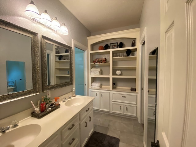 216 Dewberry Dr, Lake Jackson, TX 77566 - full bath featuring double vanity, tile patterned flooring, a textured wall, and a walk in closet