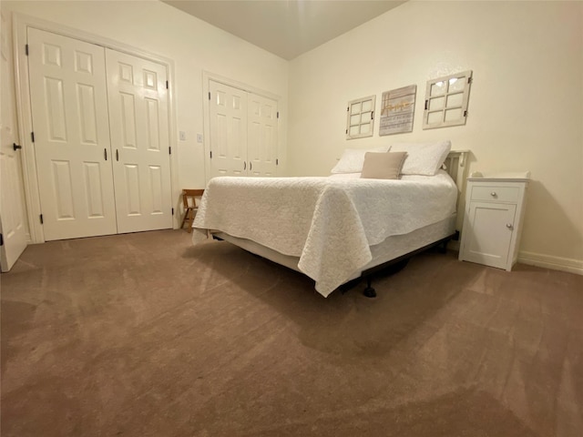 216 Dewberry Dr, Lake Jackson, TX 77566 - bedroom featuring multiple closets, dark colored carpet, and baseboards