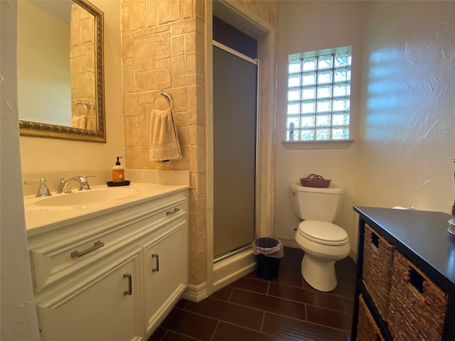 216 Dewberry Dr, Lake Jackson, TX 77566 - full bathroom featuring vanity, toilet, a stall shower, and tile patterned floors