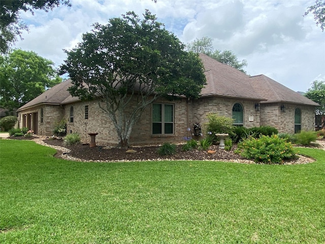 216 Dewberry Dr, Lake Jackson, TX 77566 - view of home's exterior with a yard and brick siding