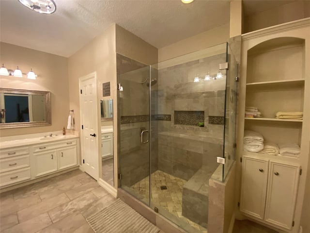 216 Dewberry Dr, Lake Jackson, TX 77566 - full bathroom with vanity, a stall shower, and a textured ceiling
